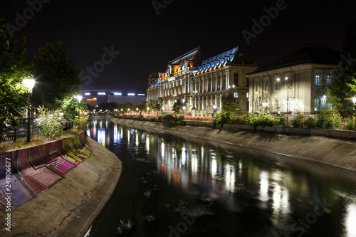 Bucharest, Romania. Palace of Justice in downtown at night, with Dambovita River in front © alpinetrail