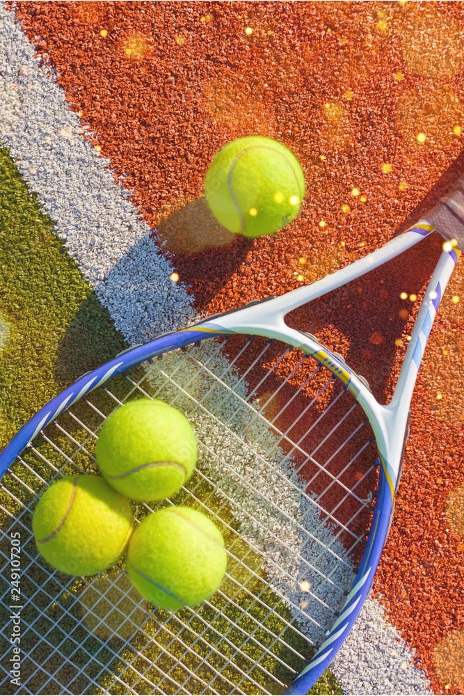 Tennis game. Tennis balls and racket on court background.