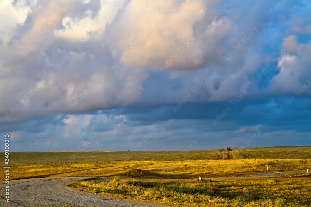The road through the sloping field before the rain.