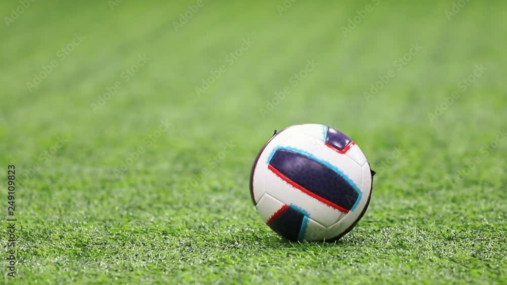 Indoor football arena. A football ball. A kid kicking it Indoor football arena. A football ball. A kid kicking it