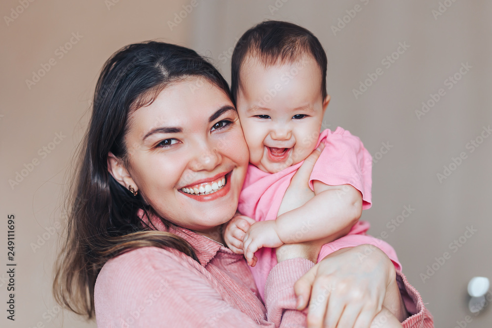 mother playing ang laughing with baby girl at home mother playing ang laughing with baby girl at home