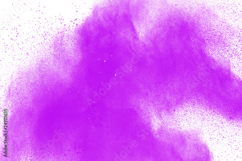 Abstract purple powder explosion on white background. Freeze motion of purple dust particle splashing.