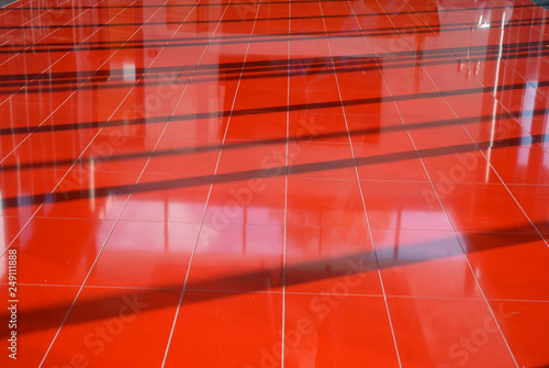 Abstract red floor structure with shadows and reflections