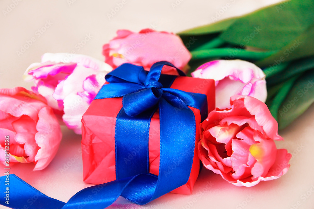pink tulips and decorative gift box with a bow for the holiday of March 8 pink tulips and decorative gift box with a bow for the holiday of March 8