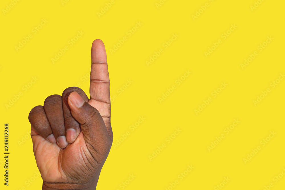 African person with raised hand asking a question or asking for permission - symbolic finger gesture for school and education.