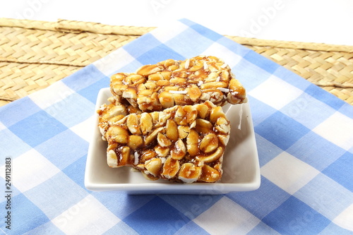 homemade traditional indian sweet chikki  or peanut candy bar made with rosated peanut and jaggery photo