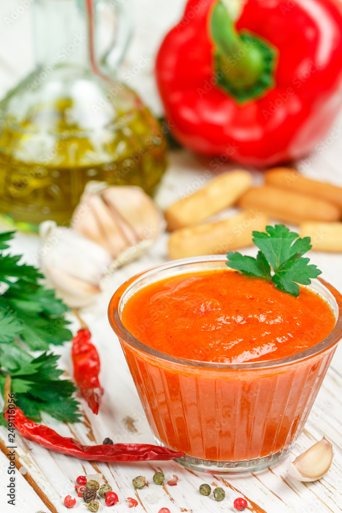 Delicious spicy dip sauce ( confiture, jam ) made of baked red bell pepper, tomatoes, garlic, spices and olive oil. Dressing for gourmets. Selective focus Delicious spicy dip sauce ( confiture, jam ) made of baked red bell pepper, tomatoes, garlic, spices and olive oil. Dressing for gourmets. Selective focus