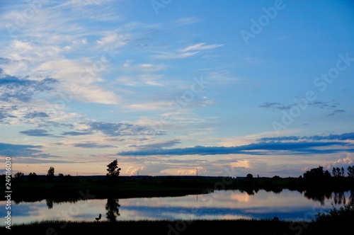 silhouette of a man on lake