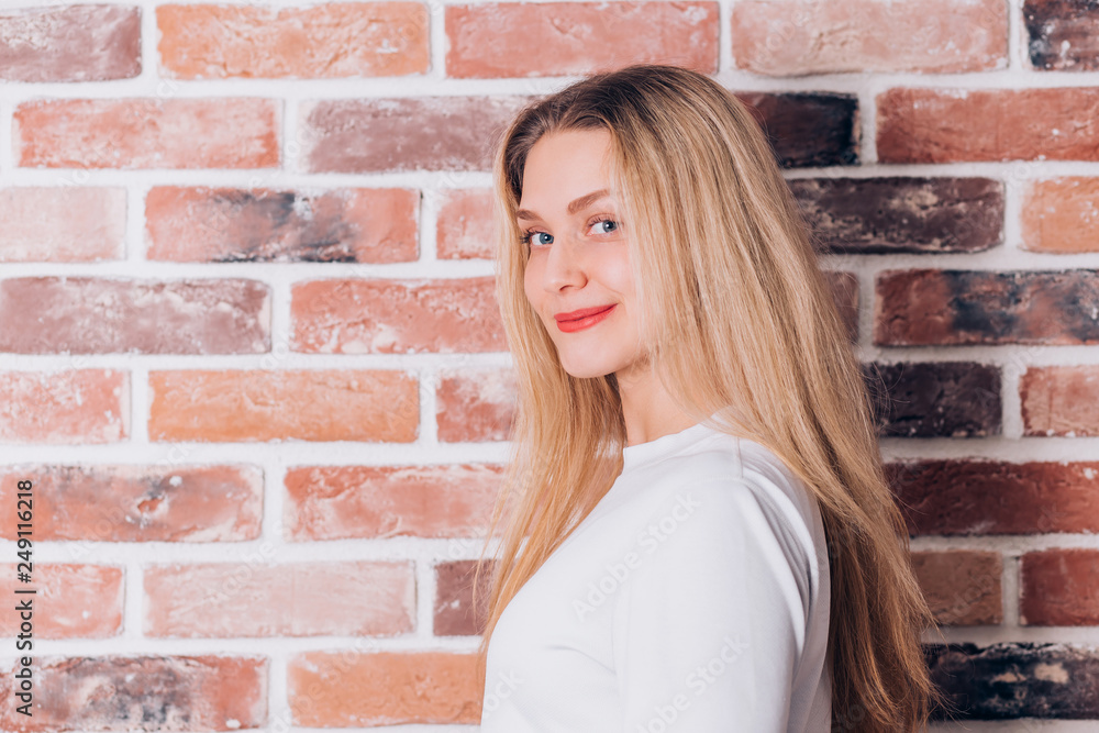 Happy cheerful young lovely blonde woman smiling and looking at the camera Happy cheerful young lovely blonde woman smiling and looking at the camera