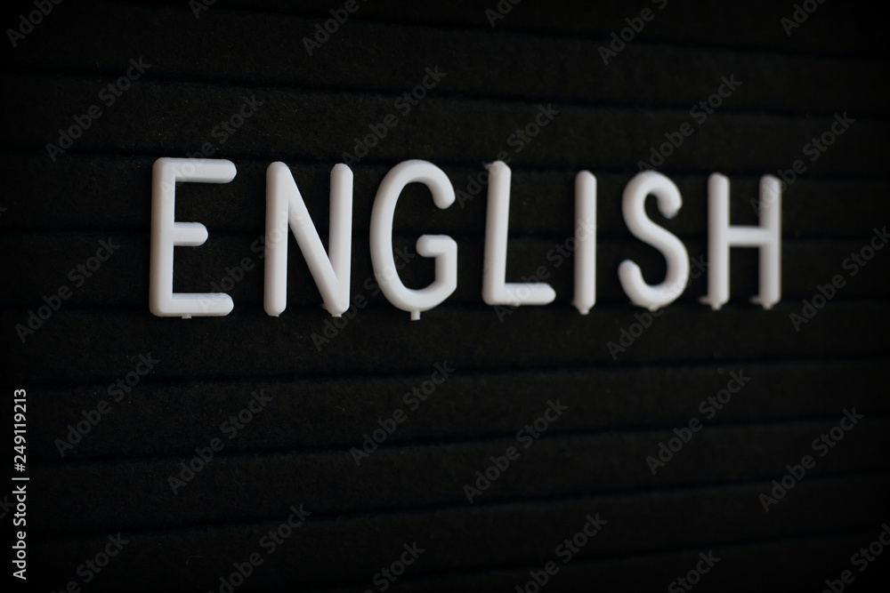 The word English in white plastic letters on a black notice board The word English in white plastic letters on a black notice board