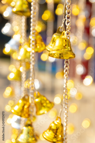 Small golden bells hanging with bokeh background
