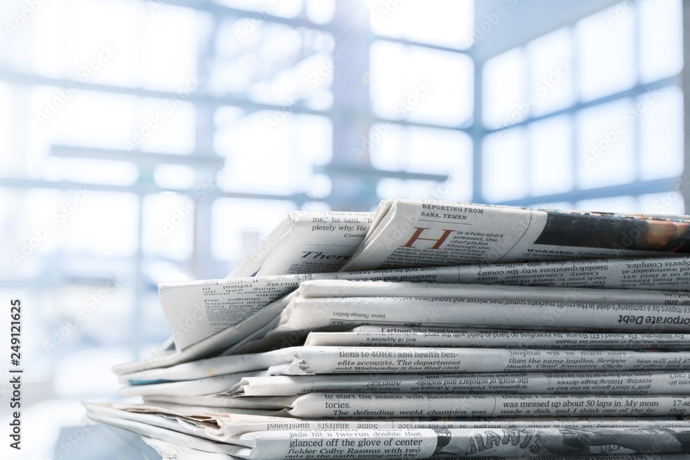 Pile of printed newspapers on white background Pile of printed newspapers on white background