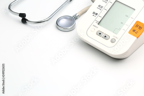 Stethoscope with Electronic Blood Pressure Monitor or Sphygmomanometer on the white background. Healthcare concept.