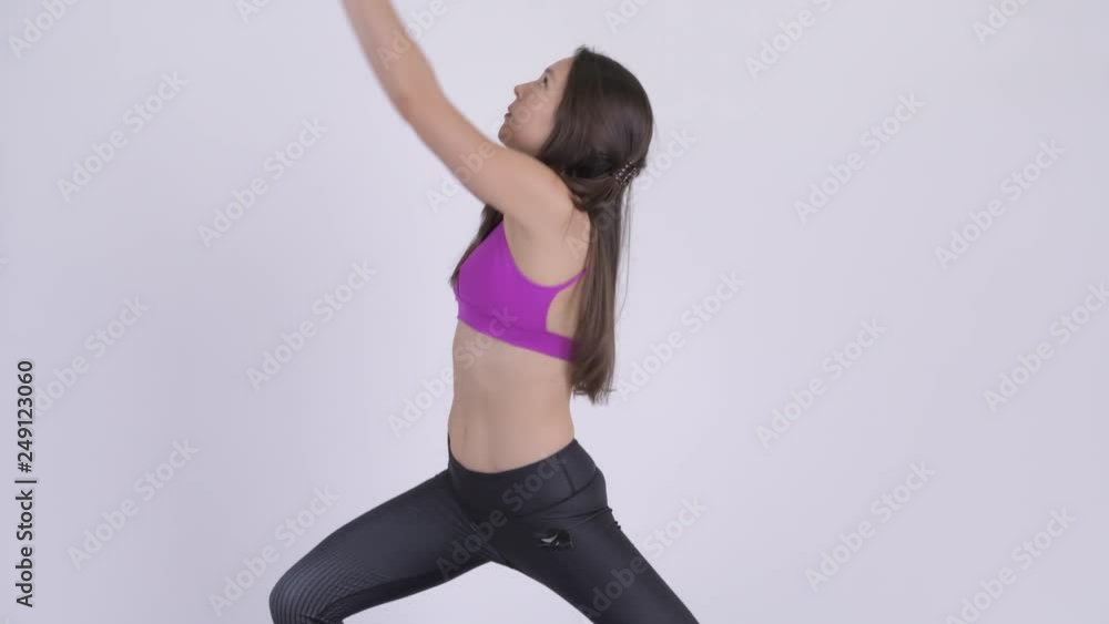 Young beautiful multi-ethnic woman doing Warrior yoga pose Young beautiful multi-ethnic woman doing Warrior yoga pose
