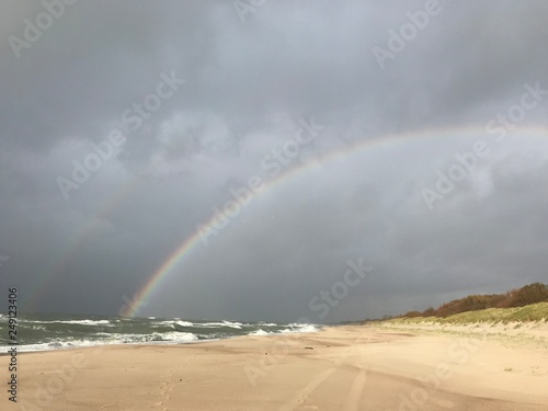 Rainbow over the beach at the coast of Baltic sea 
