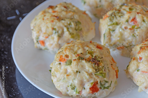 Chicken meatballs with vegetables - preparation for baked in the oven. Ingredients on the counter Healthy protein cutlets, minced cutlets. Proper, healthy food concept.