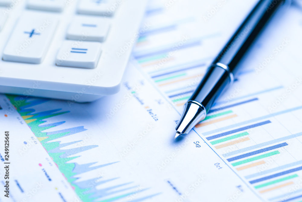pen,glasses and calculator on Financial accounting stock market graphs analysis chart pen,glasses and calculator on Financial accounting stock market graphs analysis chart
