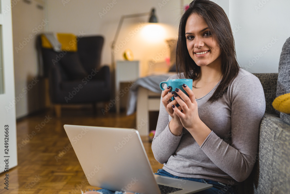 portrait of young woman using laptop at his home portrait of young woman using laptop at his home