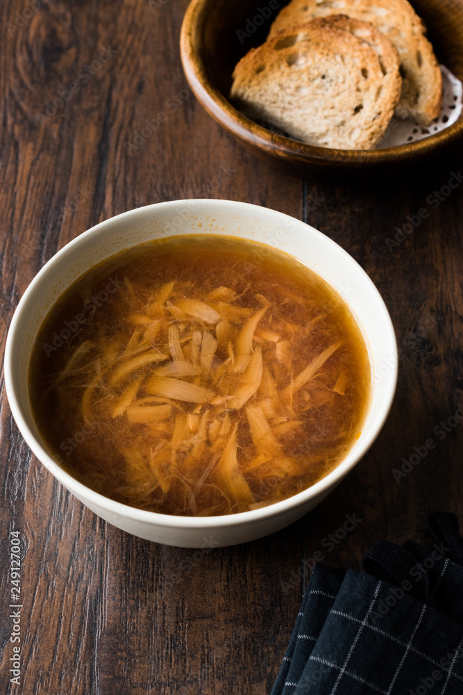 French Onion Soup with Bread on Dark Wooden Surface. French Onion Soup with Bread on Dark Wooden Surface.
