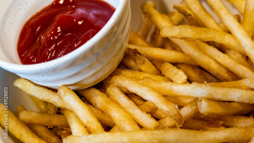 French fries in white bowl with ketchup side