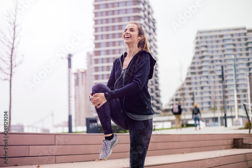 Woman performs stretching before jogging