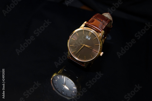 Wristwatches with leather strap on a black background