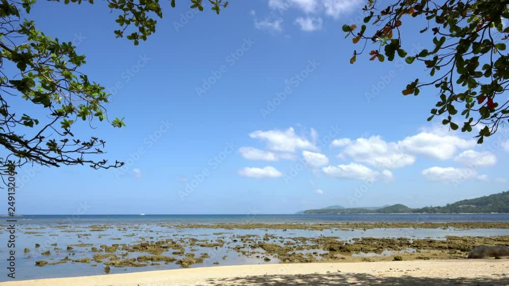exotic tropical beach with sand beach and tropical vegetation on the edge frame Beautiful white clouds moving fast in the sky exotic tropical beach with sand beach and tropical vegetation on the edge frame Beautiful white clouds moving fast in the sky