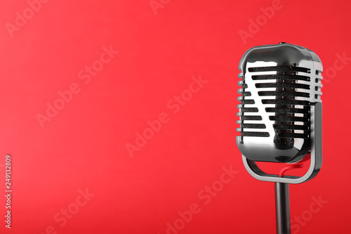 Retro microphone on color background, space for text