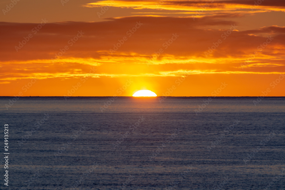 Scenic colorful sunrise over dark blue ocean water Scenic colorful sunrise over dark blue ocean water