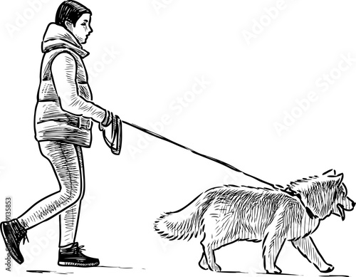 A townswoman strolls with her dog photo