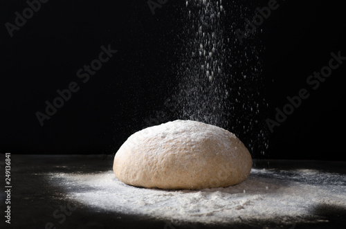 Fotografie Flour pours on fresh homemade dough