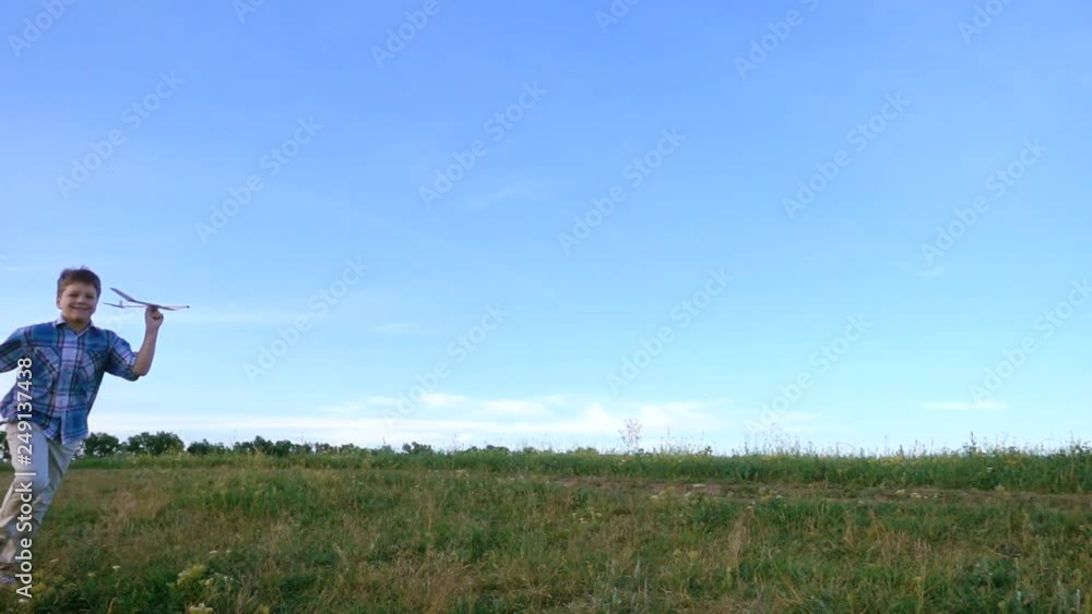 boy launching his airplane at field, slow motion boy launching his airplane at field, slow motion