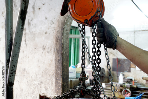 Those who are pulling chain hoists for lifting steel.