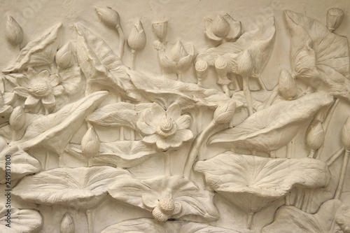 Принти на полотні Beautiful white lotus stucco patterned on the boundary wall