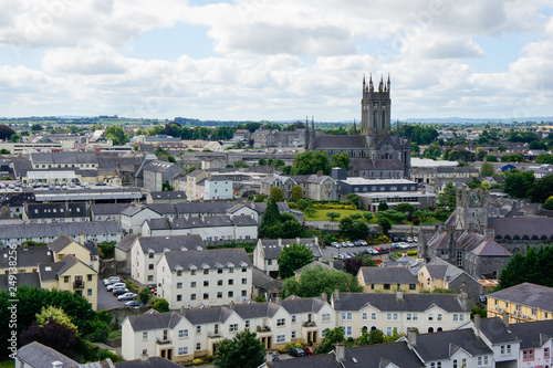Obraz na płótnie View over Kilkenny city, Ireland, from the round tower of St Canice's Cathedral with a mix of modern and medieval architecture under a cloudy sky and St Mary's Cathedral rising over the town
