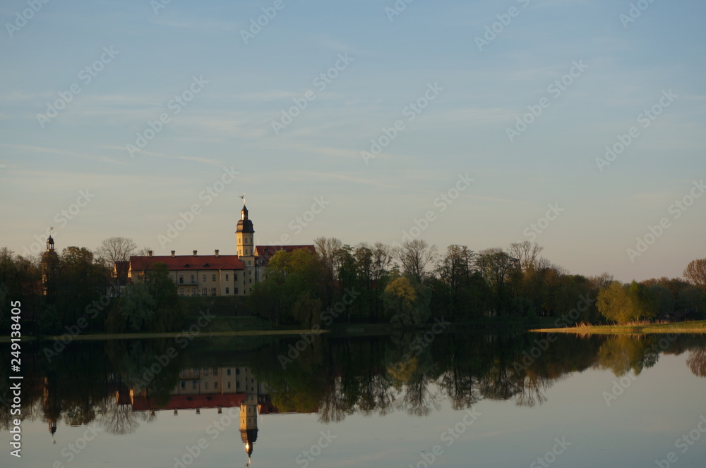 Reflection of Nesvizh Castle in the pond in autumn. Nyasvizh, Nieśwież, Nesvizh, Niasvizh, Nesvyzhius, Nieświeżh, in Minsk Region, Belarus. Site of residential castle of the Radziwill family. 