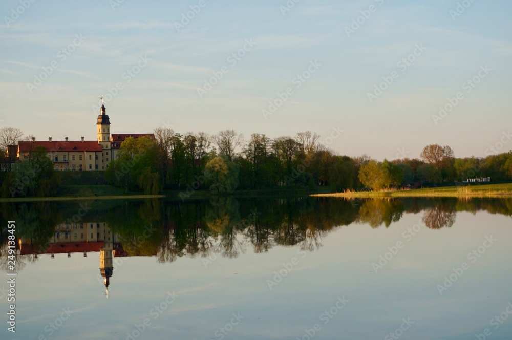 Reflection of Nesvizh Castle in the pond in autumn. Nyasvizh, Nieśwież, Nesvizh, Niasvizh, Nesvyzhius, Nieświeżh, in Minsk Region, Belarus. Site of residential castle of the Radziwill family. Reflection of Nesvizh Castle in the pond in autumn. Nyasvizh, Nieśwież, Nesvizh, Niasvizh, Nesvyzhius, Nieświeżh, in Minsk Region, Belarus. Site of residential castle of the Radziwill family.