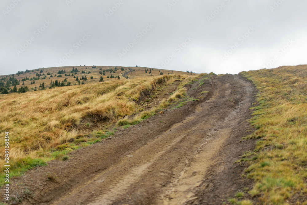 Fototapeta premium Mountain dirt road in the fall.