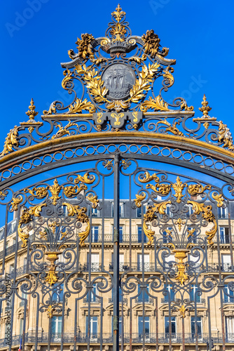 Paris, in the beautiful parc Monceau, the golden wrought iron grid, with typical buildings in background