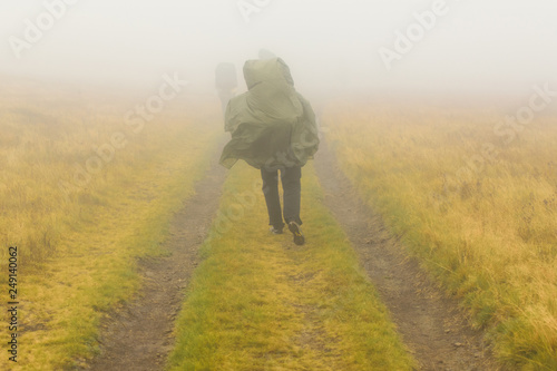 Woman with backpack hiking in the fog. © Konstiantyn Zapylaie