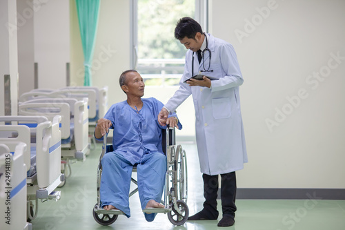 The doctor is taking care of senior patient in wheelchair