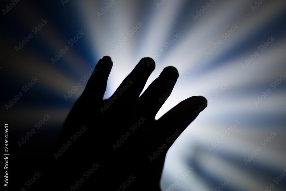The man's hand directly to the light. The idea of this picture is to catch your goal of life or dreams.