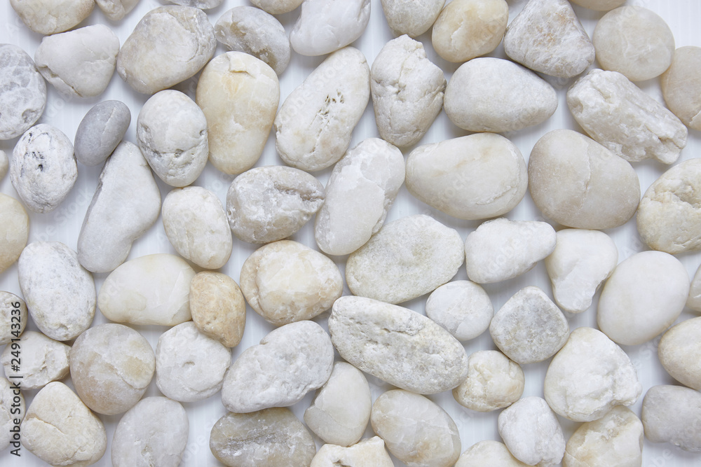 Mixed size of round pebbles stone from sea beach background texture