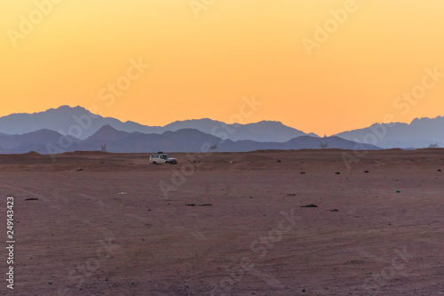 Off road SUV car in Arabian desert at sunset