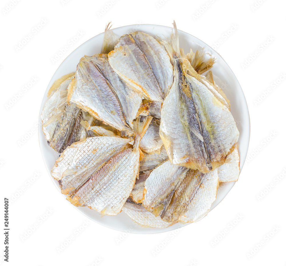 Dried fish in a round plate isolated on white