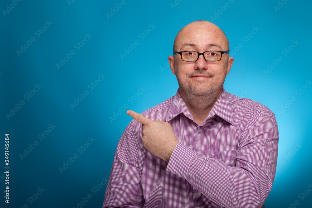 A businessman in a piked shirt pointing with the index finger A businessman in a piked shirt pointing with the index finger