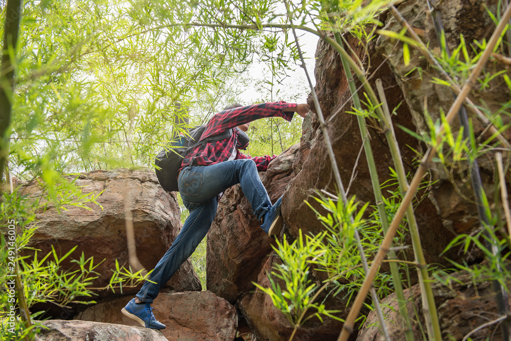 Asian man climbing rock mountain on sunset Asian man climbing rock mountain on sunset