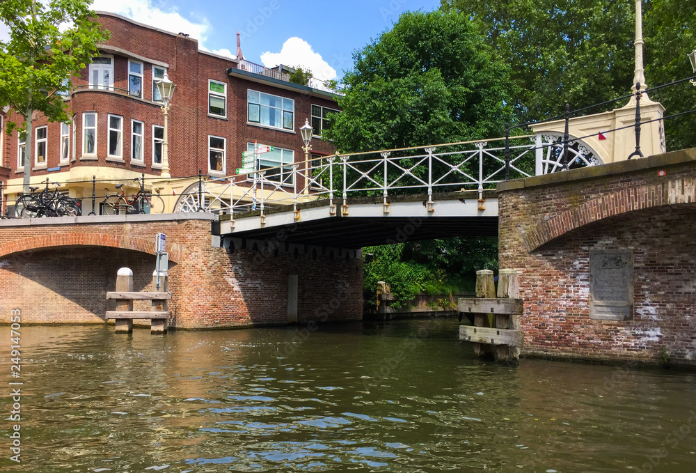Amazing view from tourist boat on one of the bridges of Oudegracht (Old Canal) and beautiful buildings of Utrecht, Netherlands