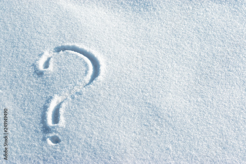 Question mark in the light blue bright snow. Leftside view