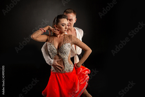 Couple dancing, elegant man and woman in studio